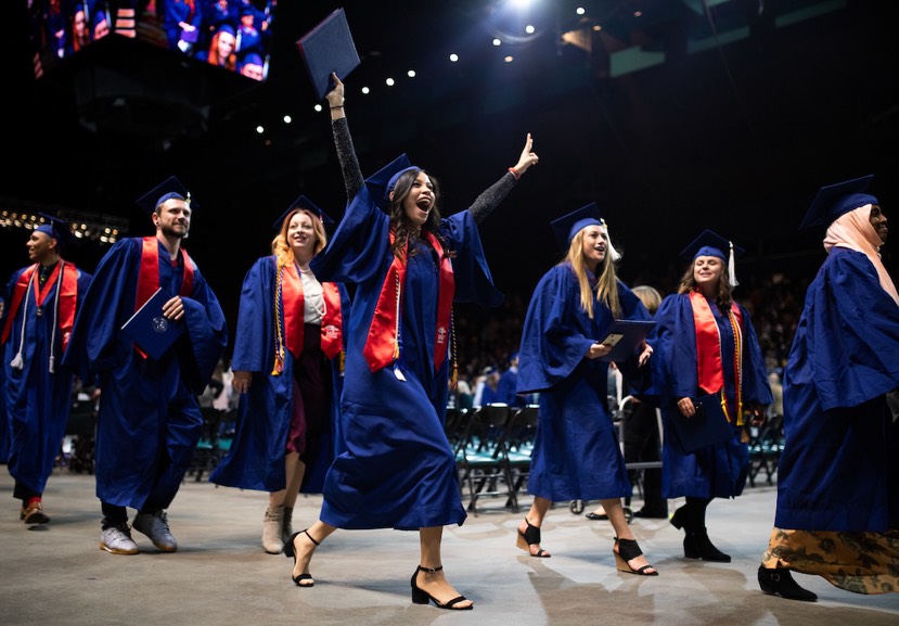 Collection of graduating MSU Denver students with the center woman celebrating