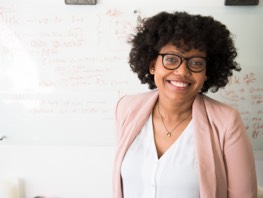 Smiling woman in front of whiteboard
