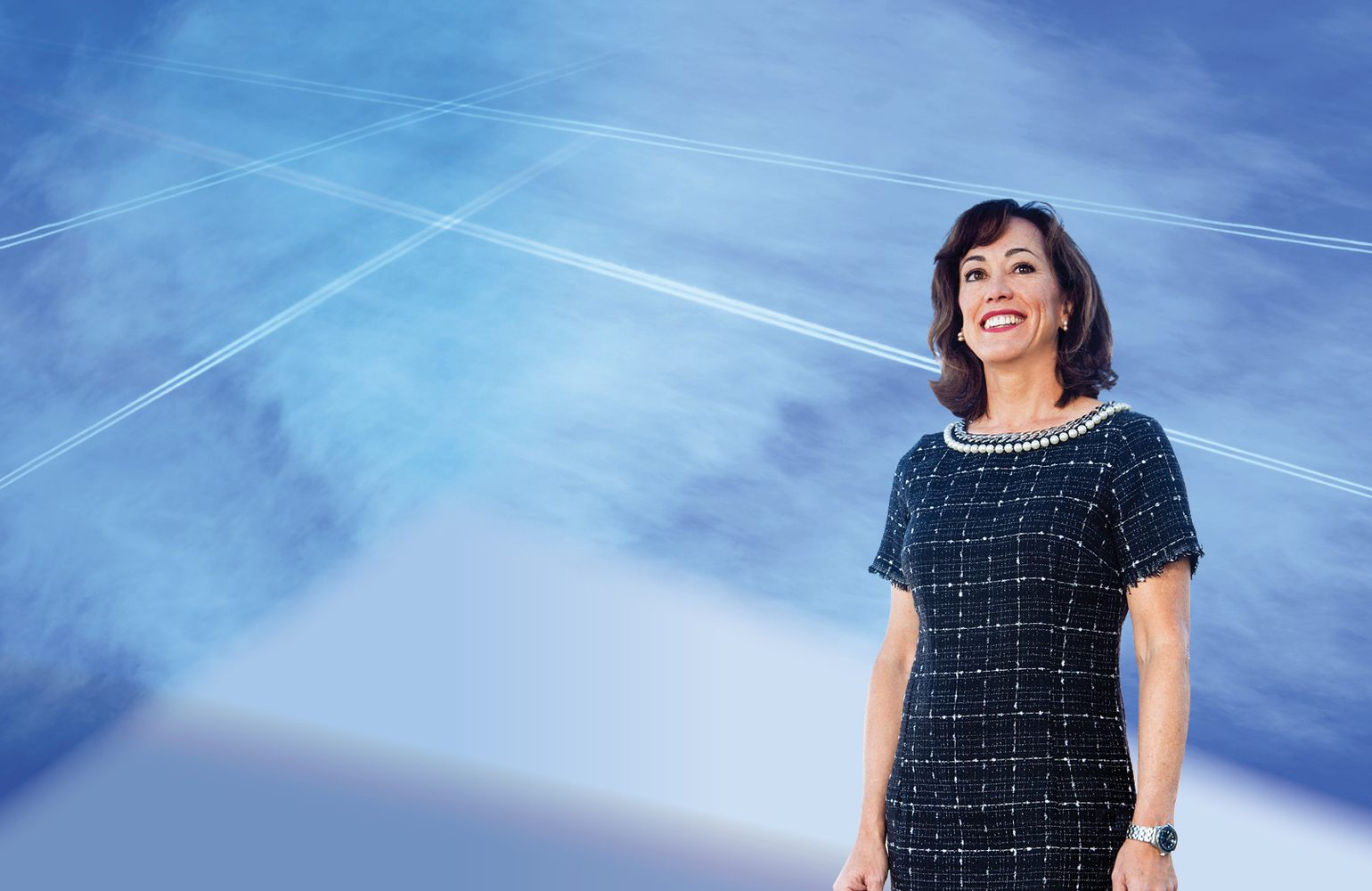 President Janine Davidson in front of blue background