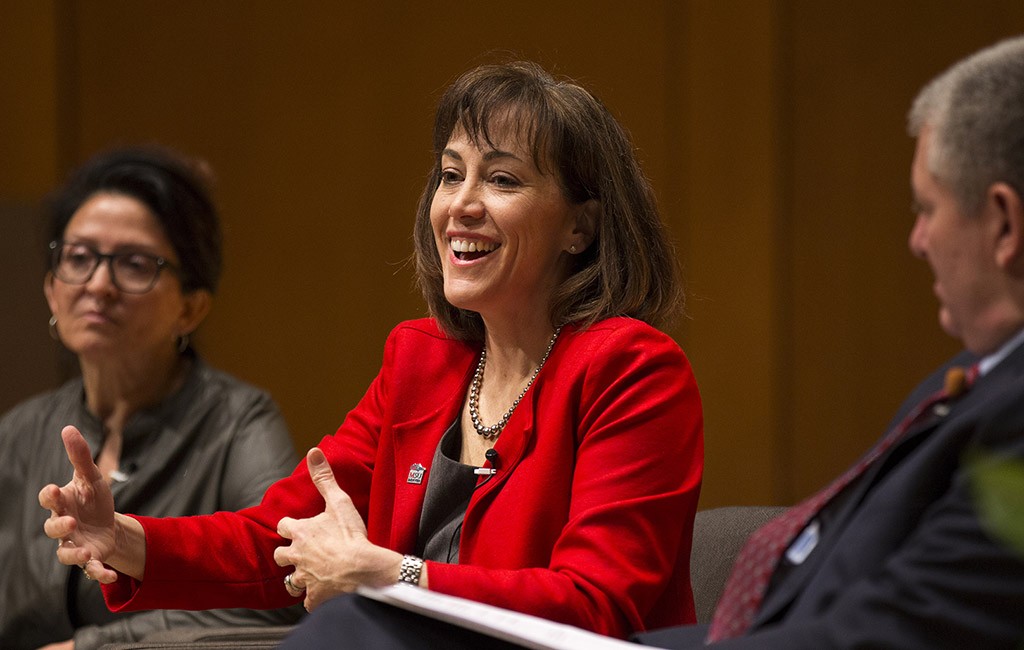 President Janine Davidson smiling on a panel