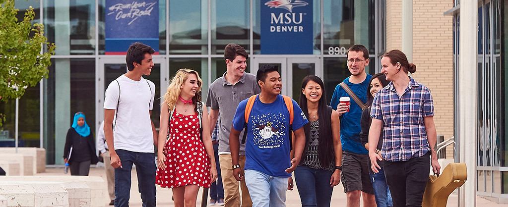 A group of friends walking in front of the Jordan Student Success Building