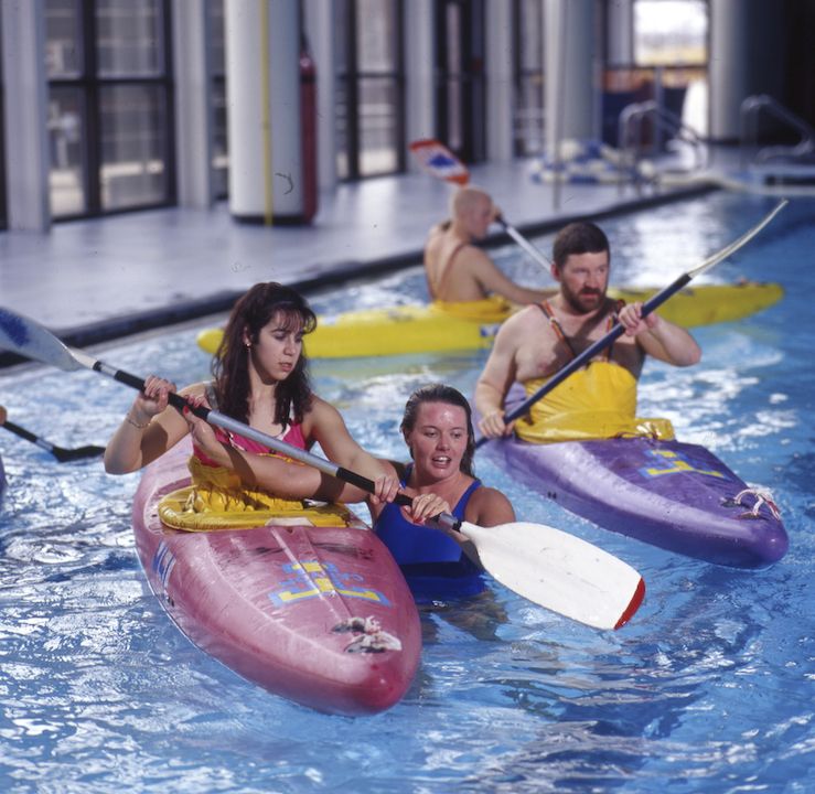 Students kayaking in the pool for a class