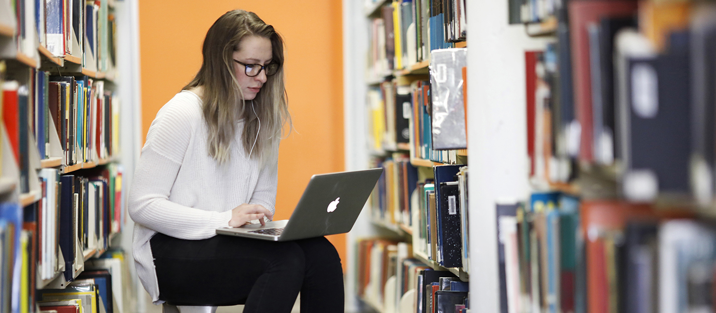 Student studying in library.