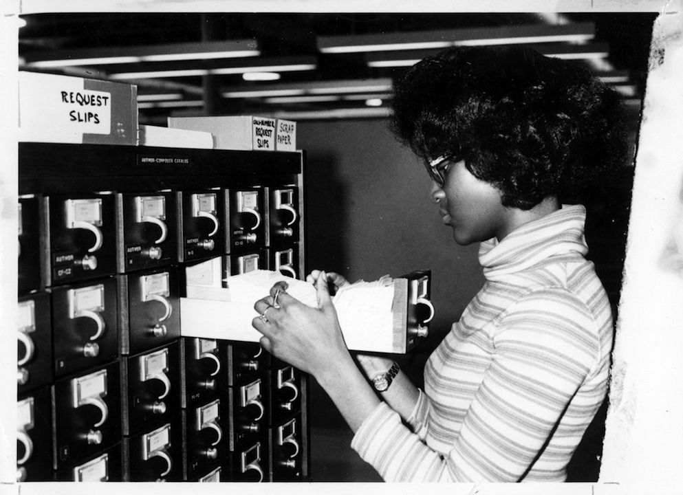 Student searching for a text in MSU Denver's first library