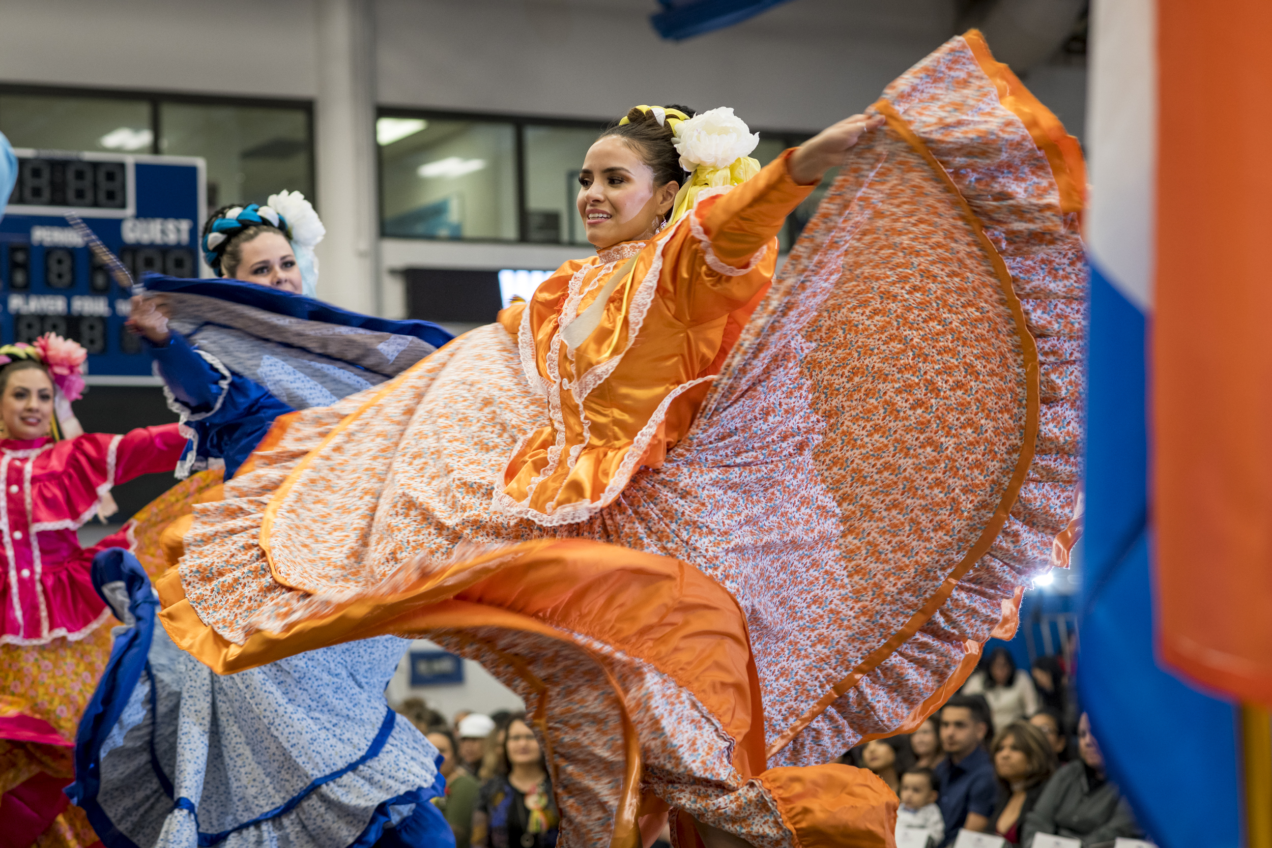 Latin dancers spinning in their flowy dresses