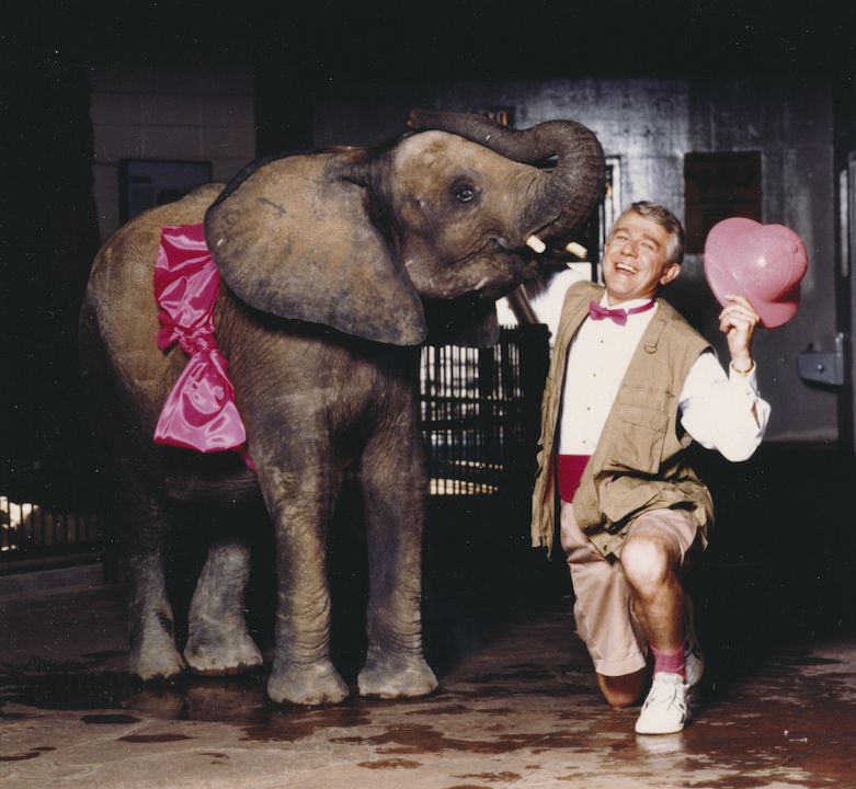 Representative Paul Schauer posing with an elephant