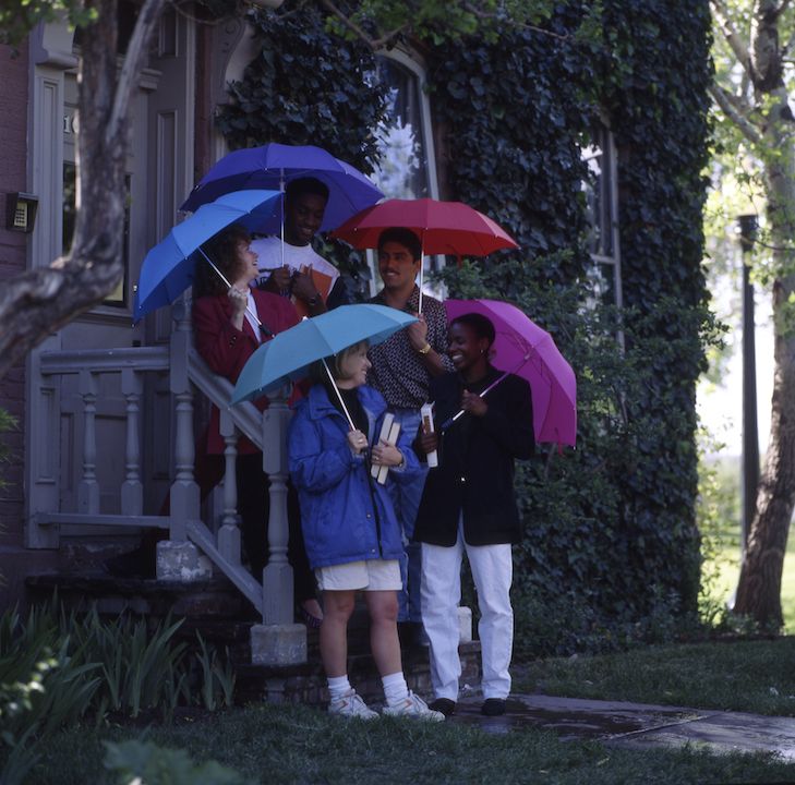 Roadrunners outside holding umbrellas