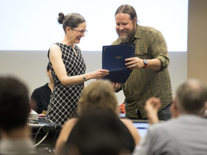 Faculty Member handing out an award