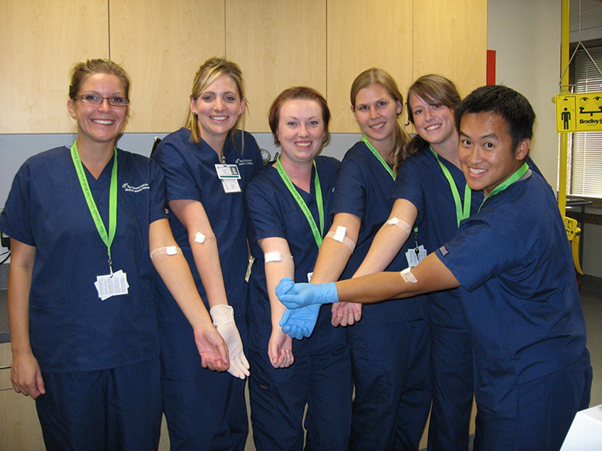 Students displaying successful phlebotomy sticks.