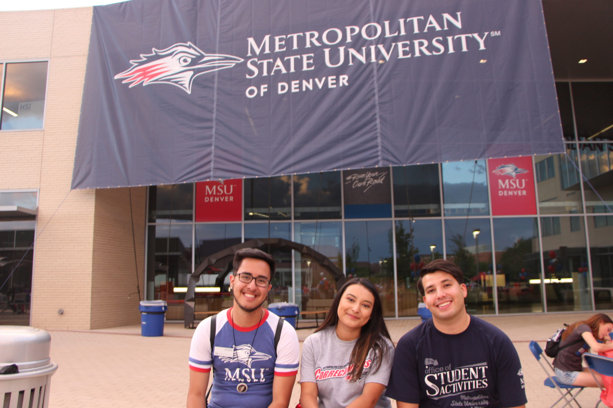 Student Activities team in front of the Student Success Building smiling at the camera