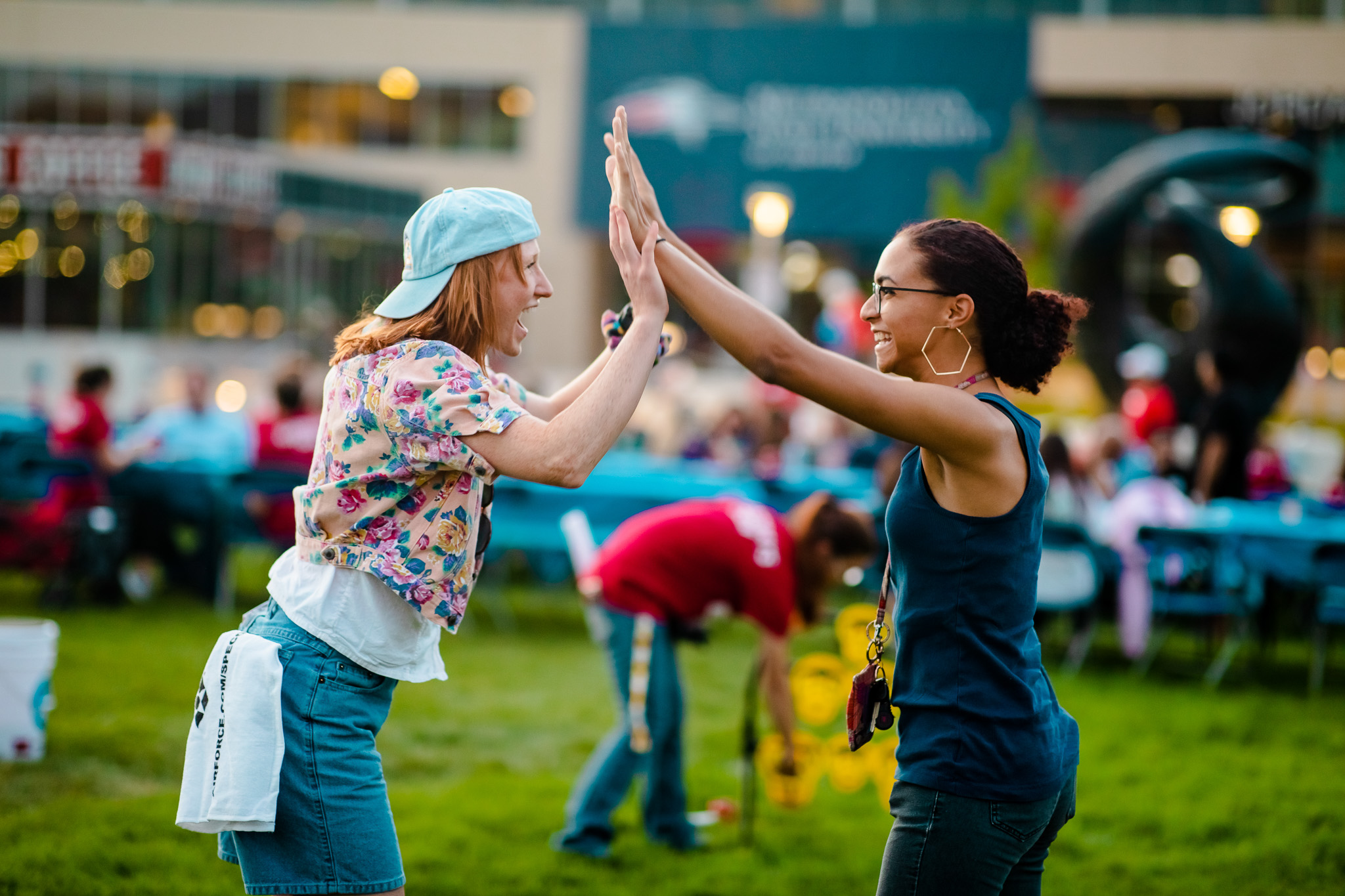 Two participants having a double high five during a challenge