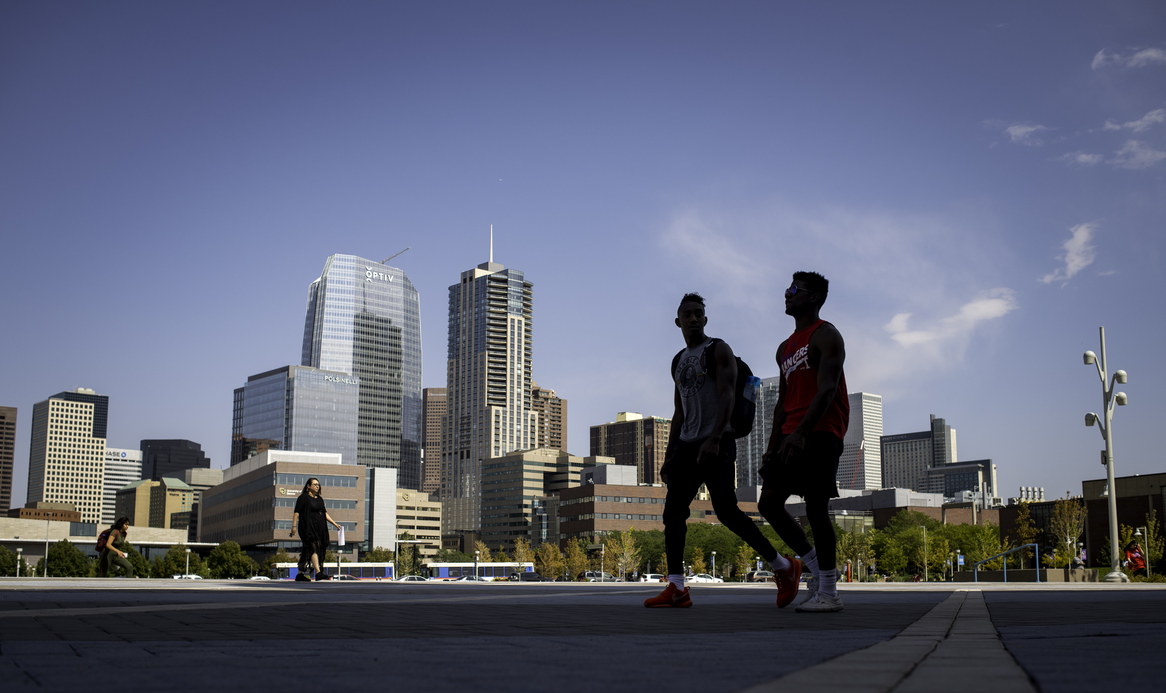Two men shadowed in foreground with Downtown in background