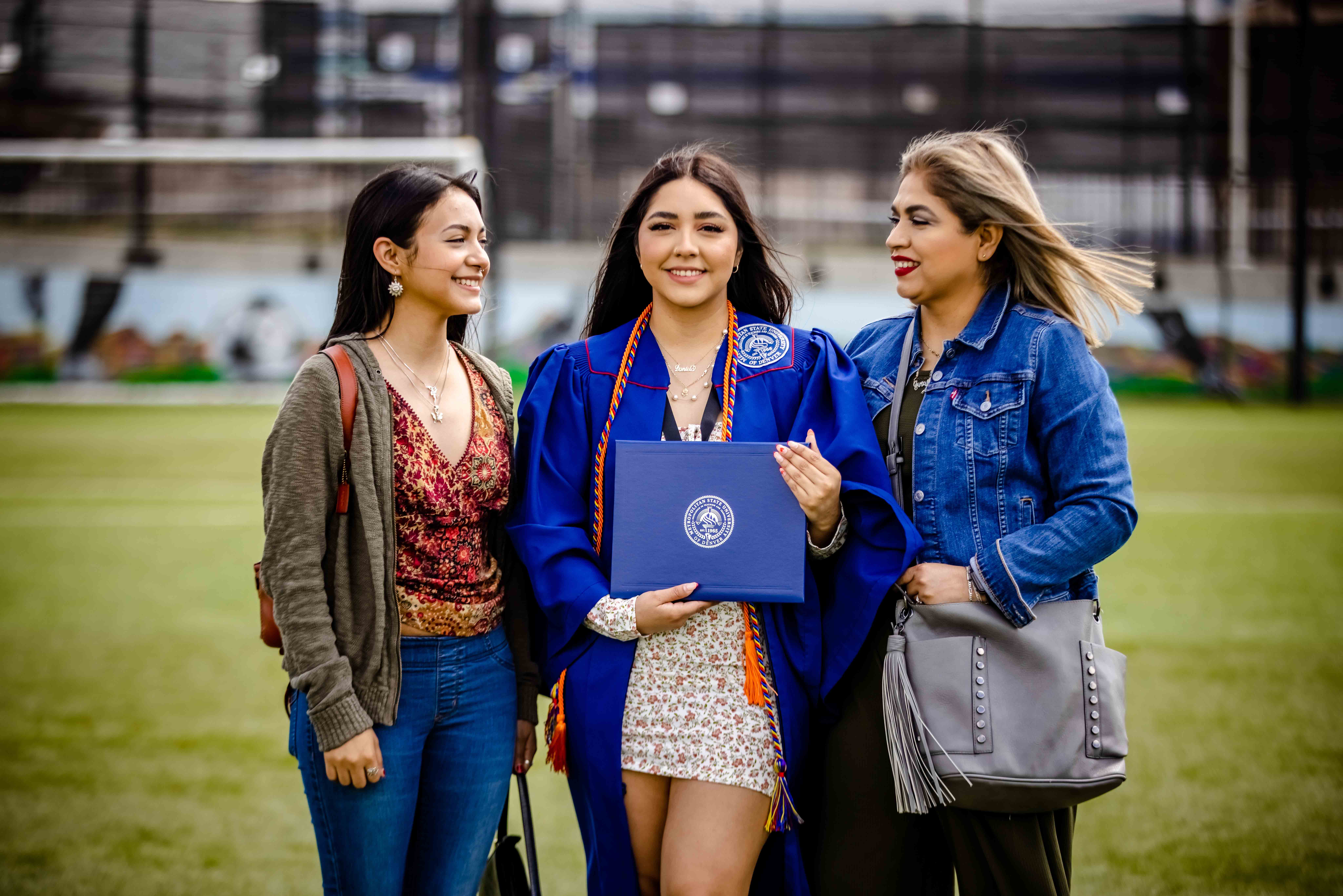 Graduate standing with their family after the ceremony