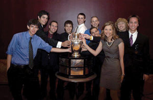 Aviation and Aerospace members standing with trophy