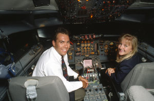 Pilots smiling in the cockpit of a plane