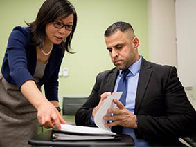 Two people looking at paperwork together