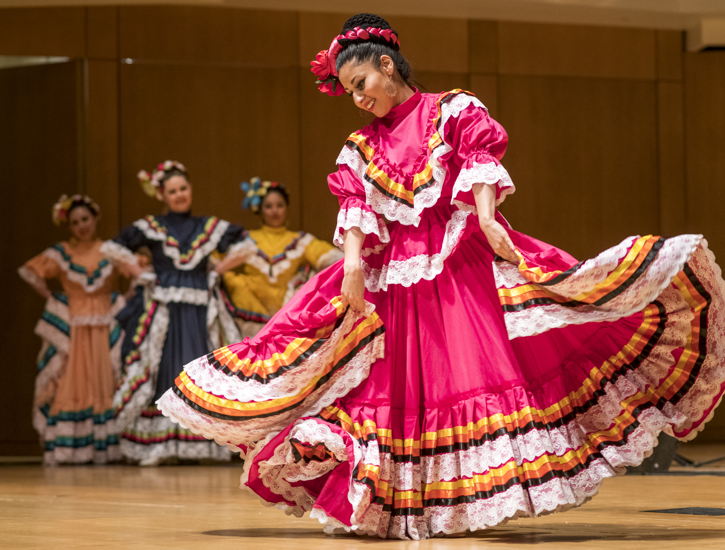 Folklorico dancer is traditional pink dress