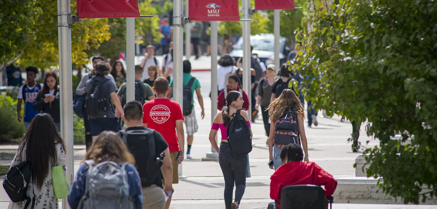 Students walking on Auraria campus in summer with MSU Denver banners above