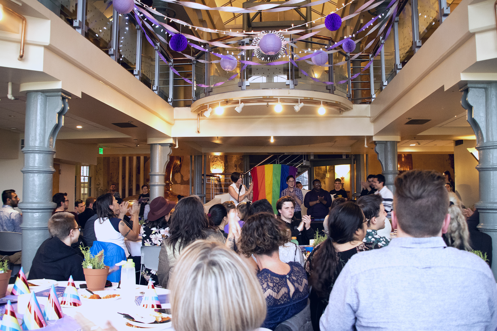 An overview of the ceremony with all of the decor hanging and families in the room