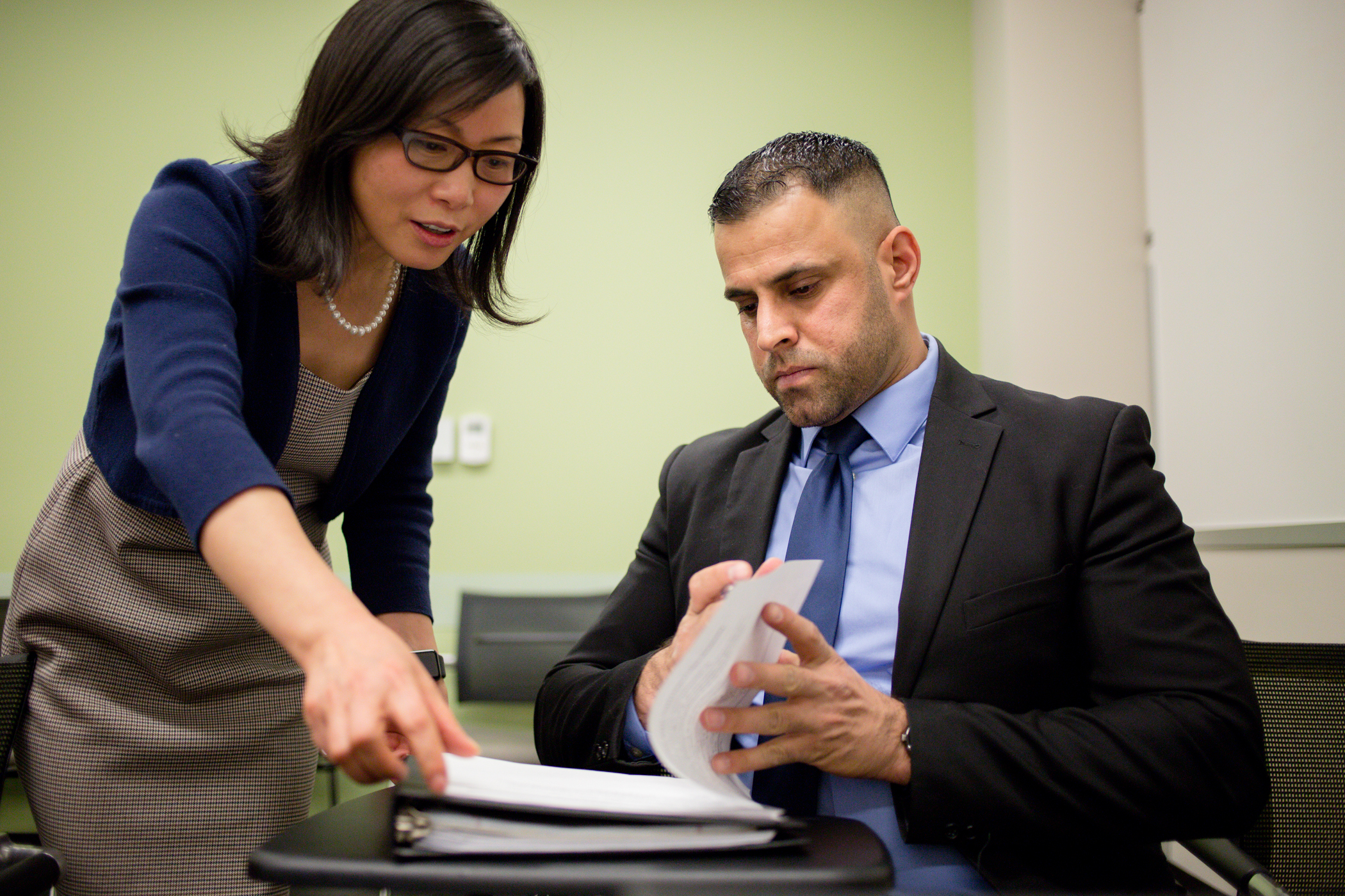 Female reviewing documents of a male