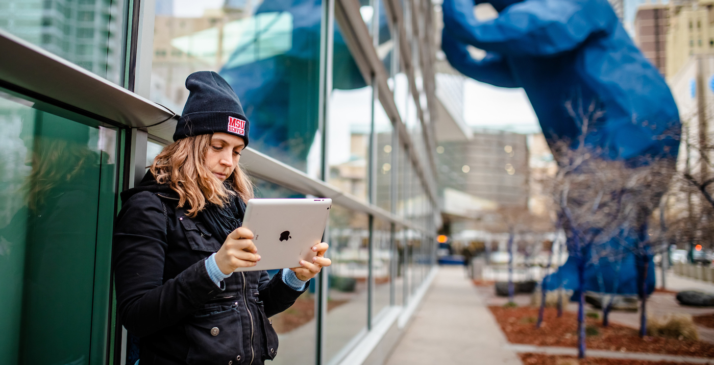 MSU Denver student with ipad near conference center downtown