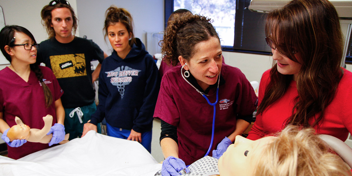 Nursing students working with clinical faculty