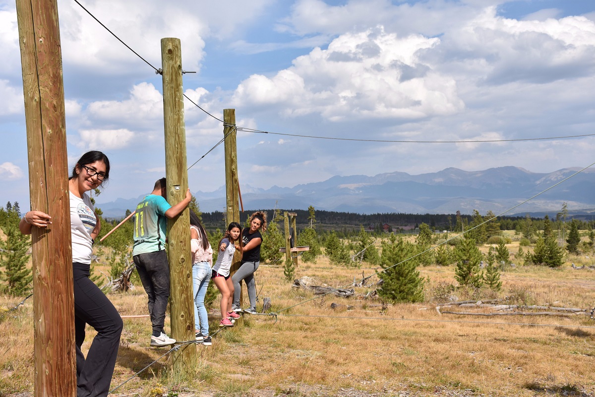 CAMP students doing a ropes course on retreat