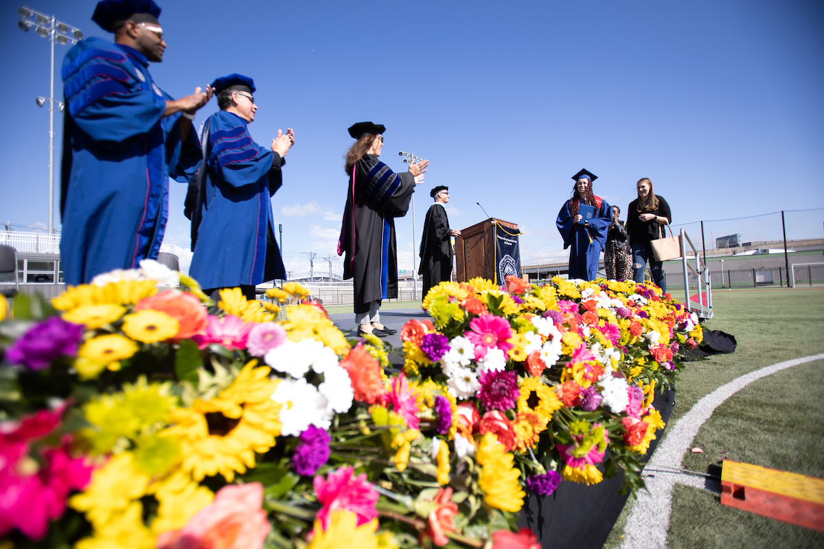 MSU Denver student walking across the stage at Spring 2021 Commencement