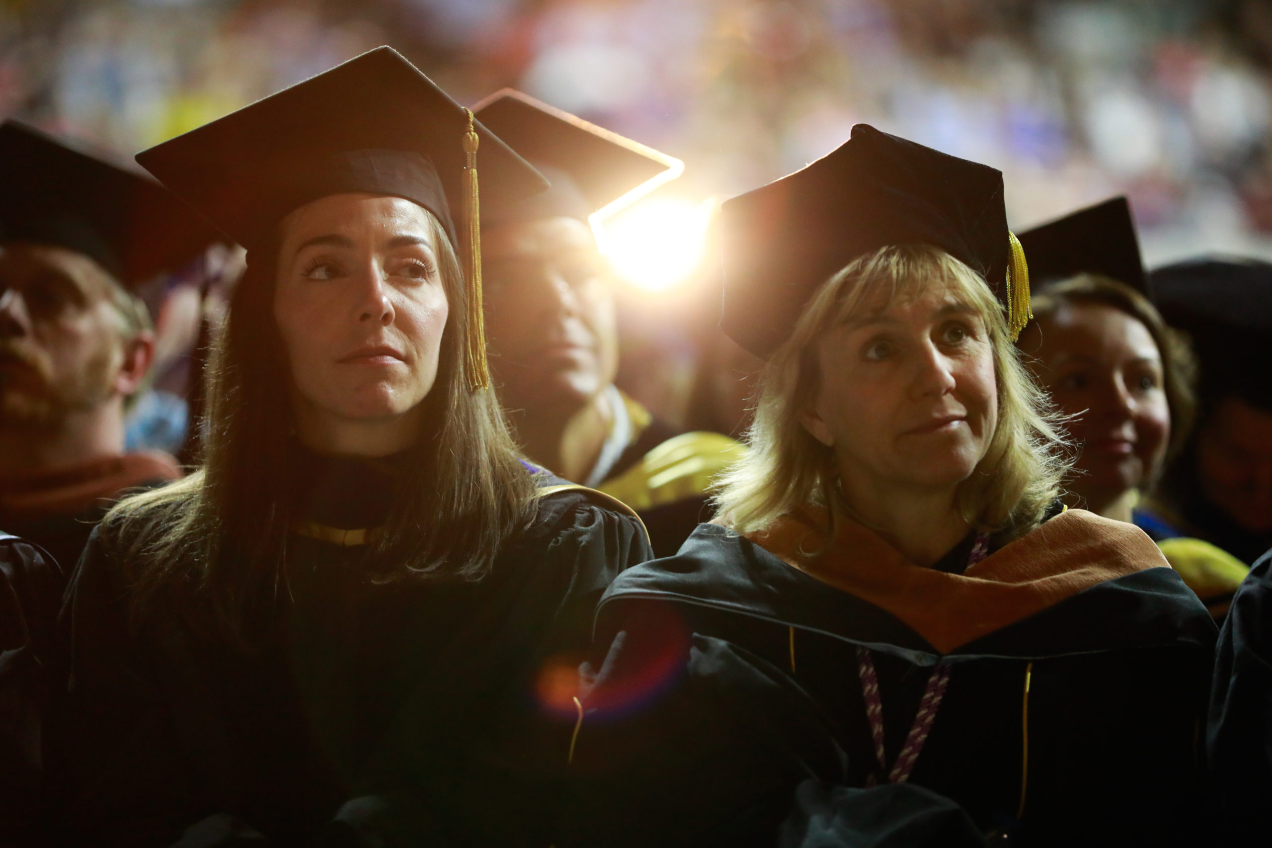 Faculty and staff sitting in the audience at the commencement ceremony