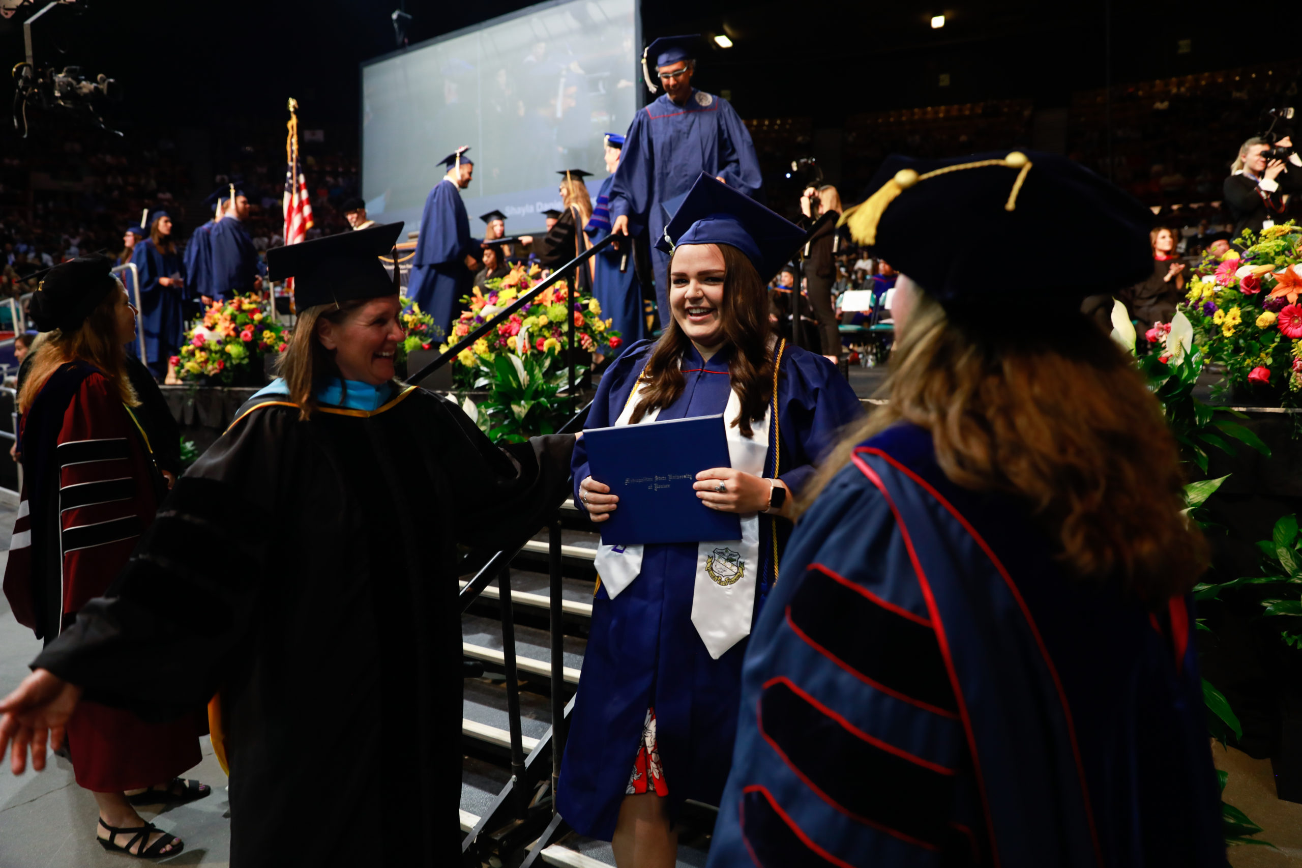 Faculty greating studetns as they exit the ceremony stage