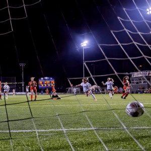 soccer ball kicked in goal net.
