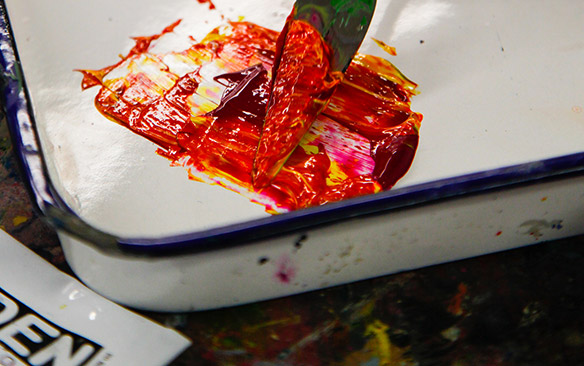 Closeup of a mix of paint with a painting knife.