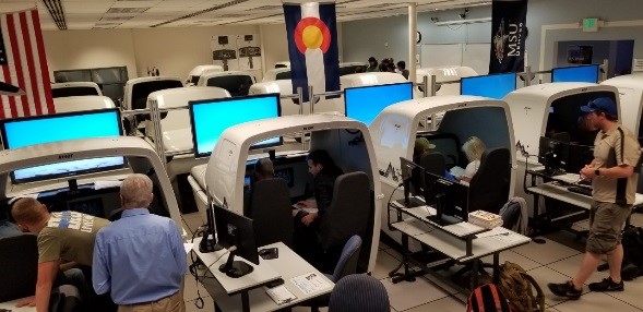 AVS faculty member instructs students utilizing flight simulation technology.