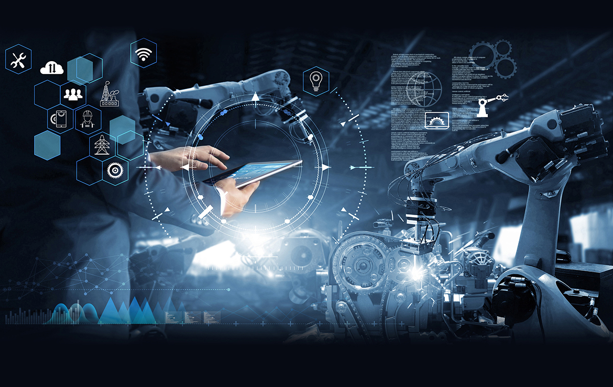 Man workng on a tablet in a lab with robotic arms and a view of digital work instructions and icons