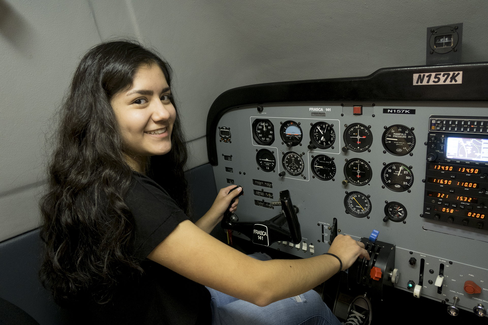 Student at the controls of a plane simulator