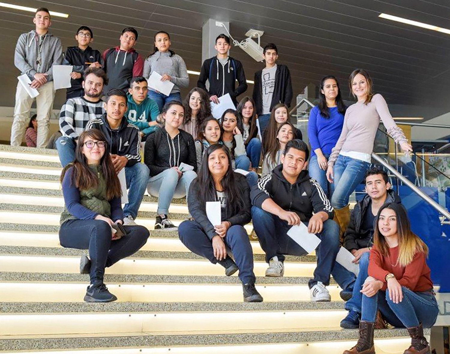 Group of high school students sitting on stairs