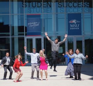 CESA team jumping in front of the Jordan Student Success building