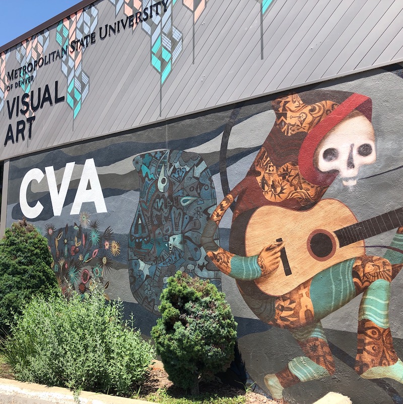Exterior front door of CVA depicting a hoodie-clad skeleton playing an acoustic guitar.