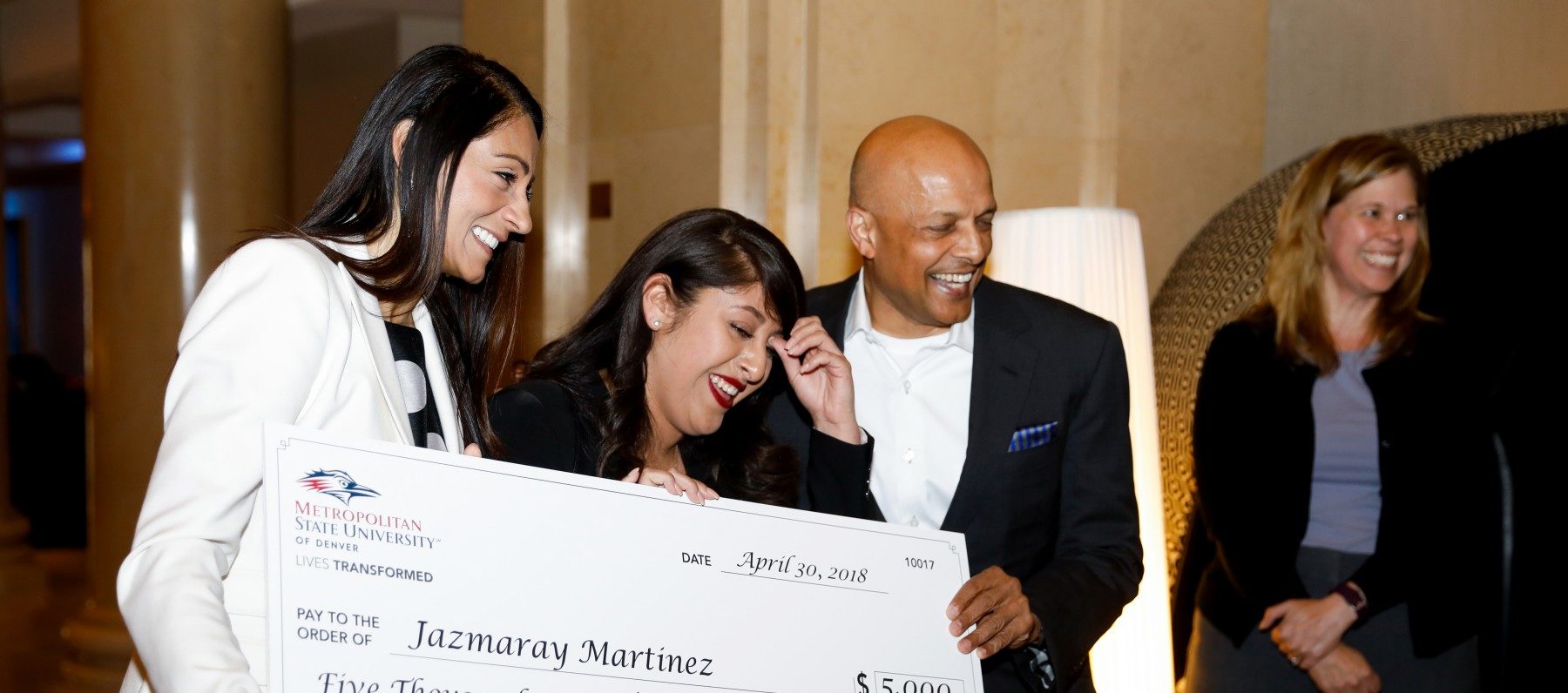 MSU Denver's Dimond Scholarship Winner holding a large check