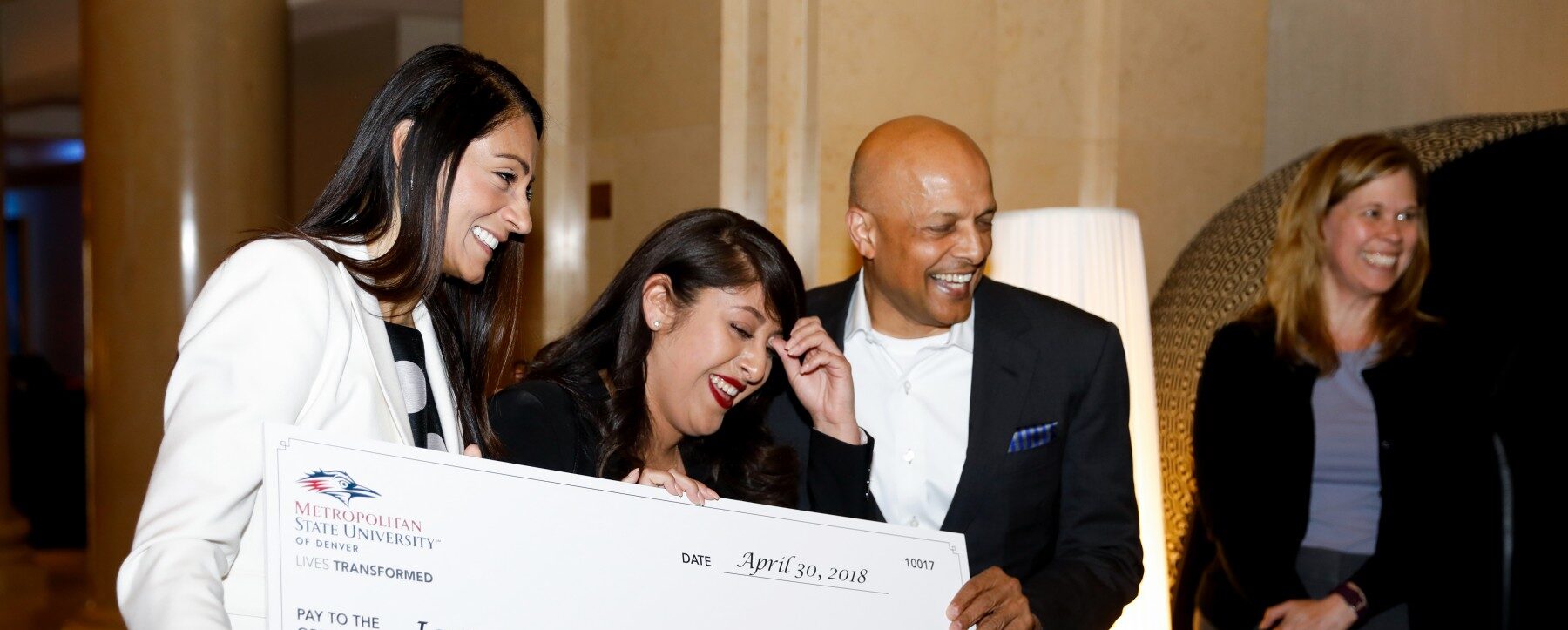 MSU Denver's Dimond Scholarship Winner holding a large check