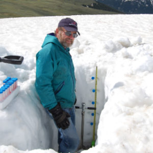 Dr. Andy Evans standing in a chest high snow pit.