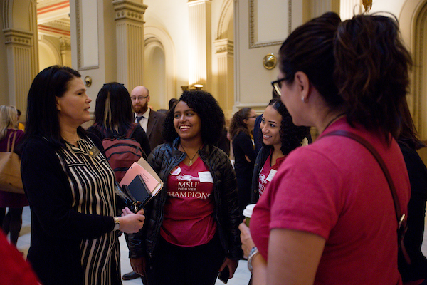 students talking at the capital