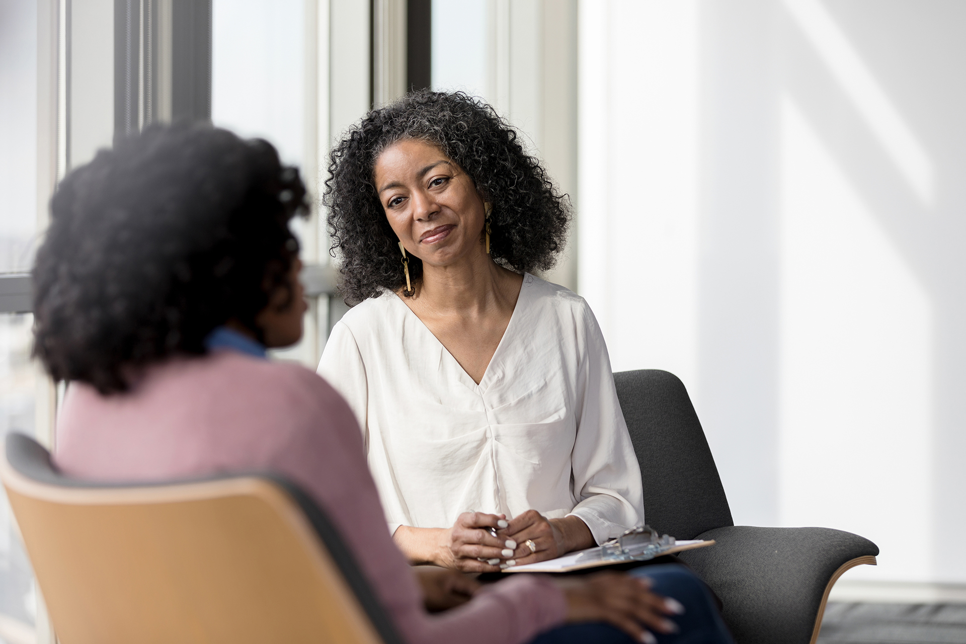 Mature healthcare worker in conversation with patient