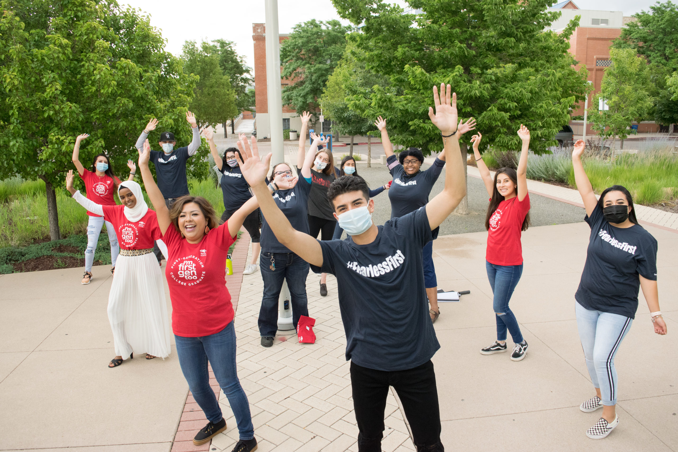 fearless students with hands in the air