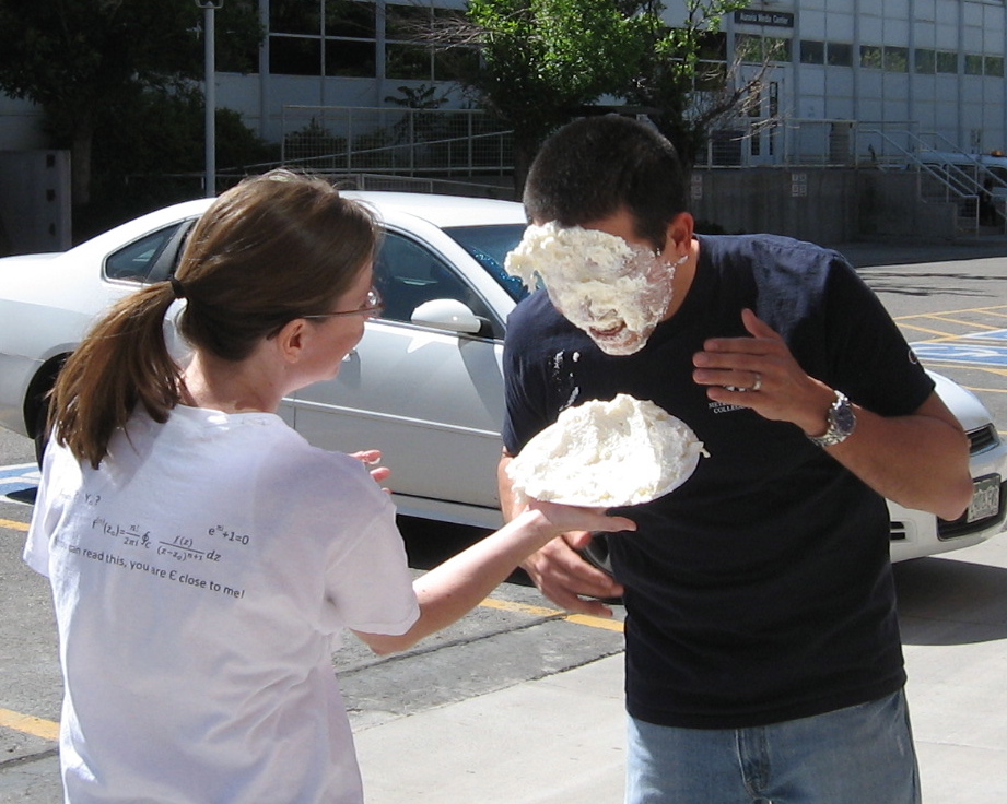 A student getting a pie shoved in their face to celebrate 