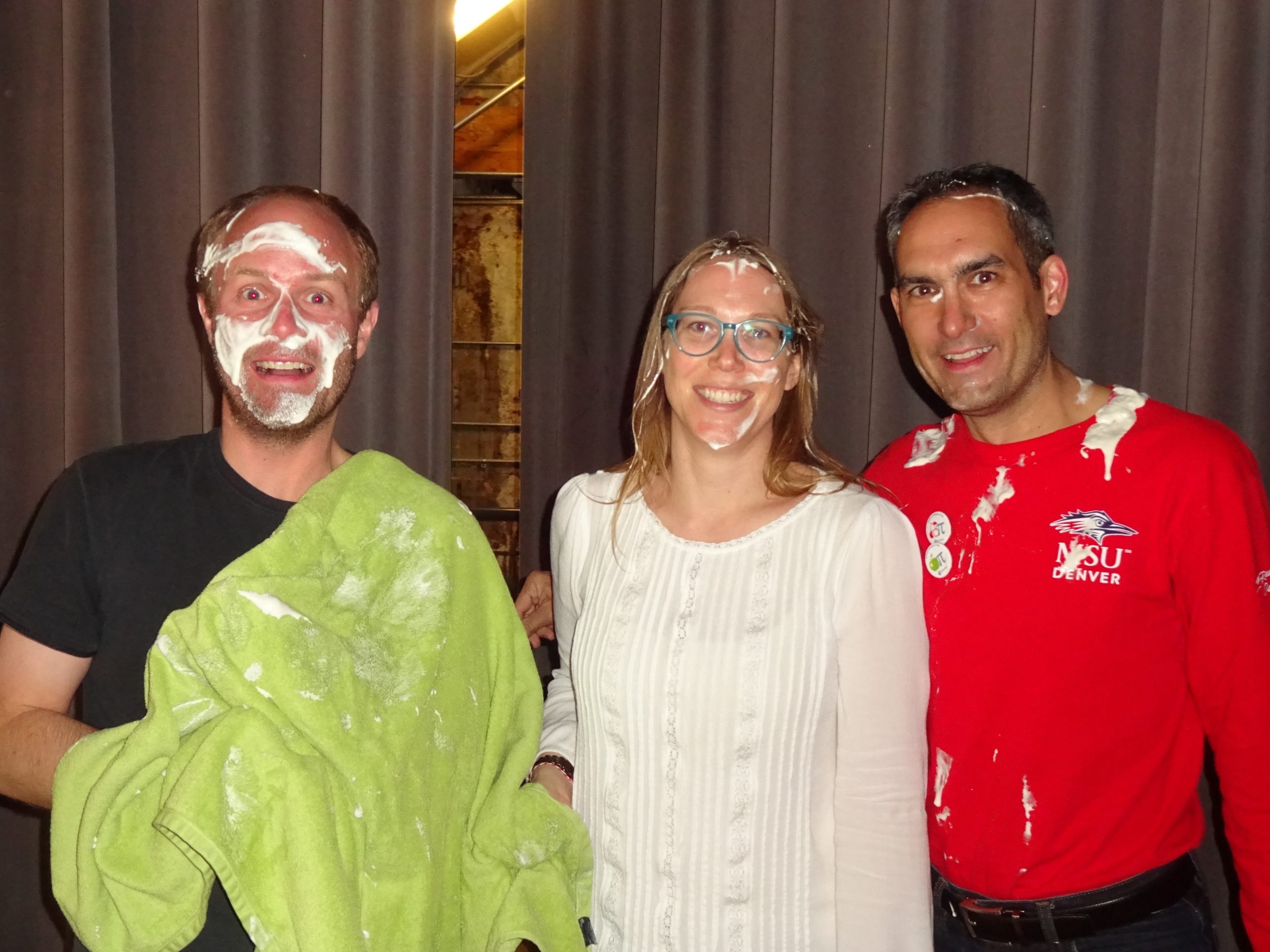 Teachers posing with whipped cream on their faces after being smushed with pies during 