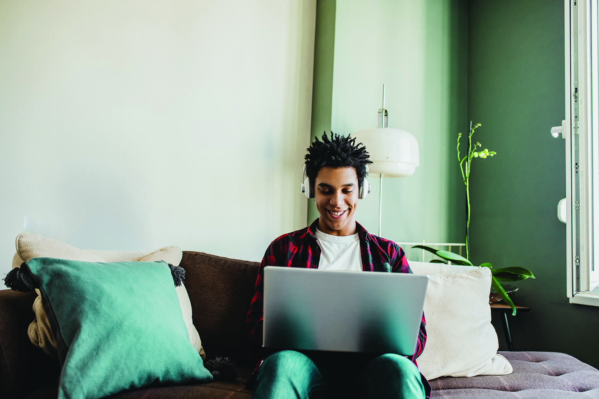 Student using his laptop at home