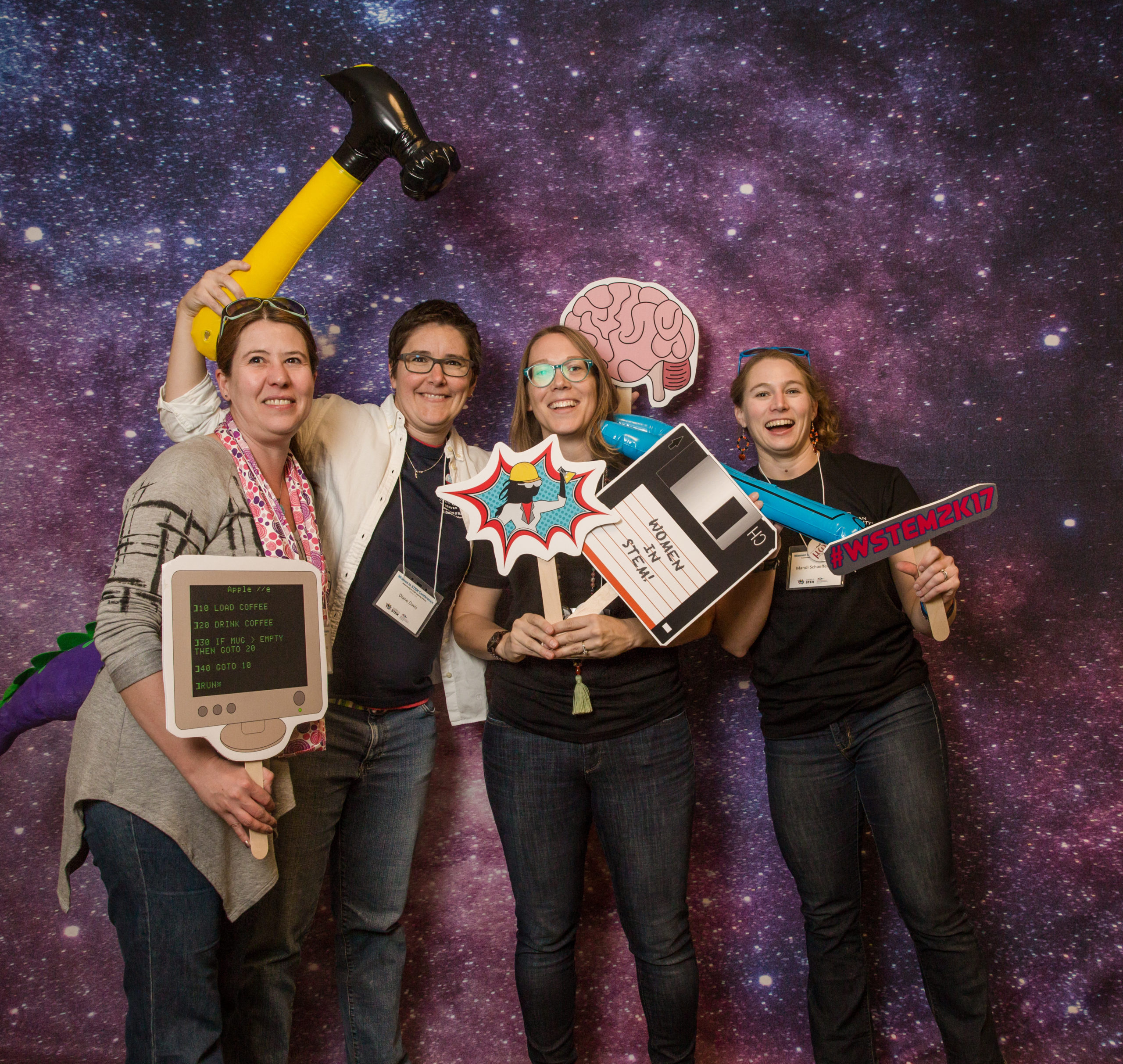 Math and Stats faculty taking a silly picture in front of a galaxy-themed backdrop.