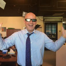 Chris Spears standing in a tv studio office