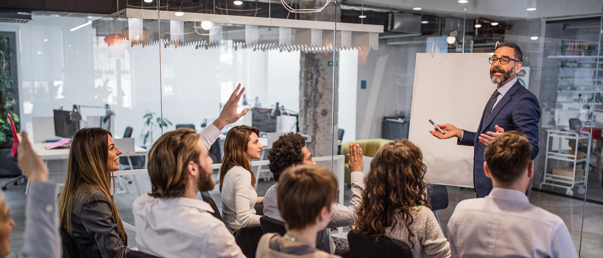 Business man giving training to team in a conference room with a whiteboard